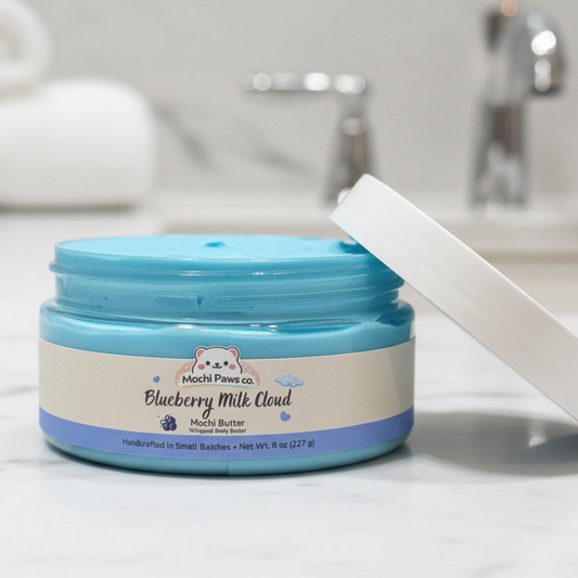 Jar of Mochi Paws co. Blueberry Milk Cloud Mochi Butter on a bathroom counter.