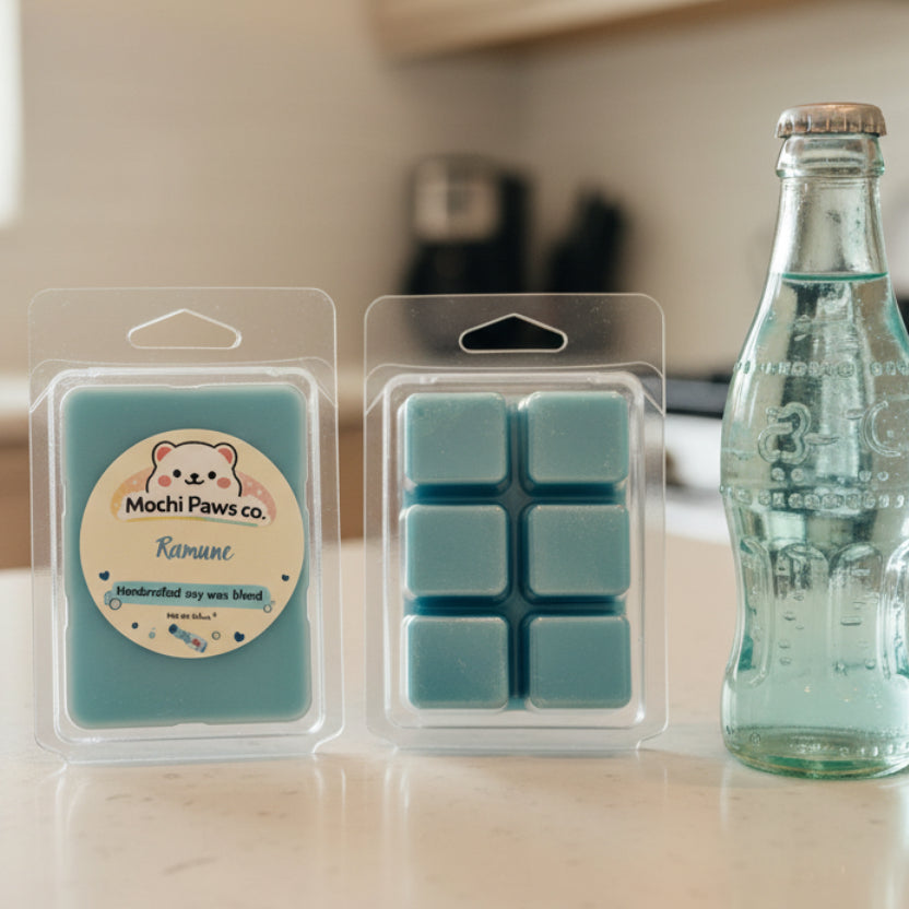 Two packages of blue wax melts with a Mochi Paws Co label on a light gray background