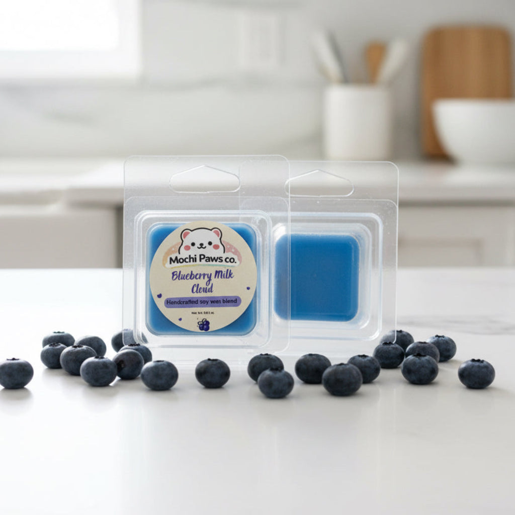 Two packages of blueberry milk cloud scented wax melts from Mochi Paws Co. on a gray background.