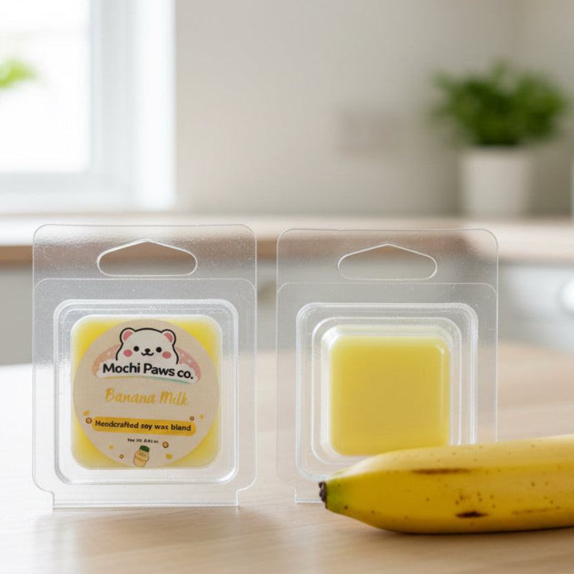 Two packages of Mochi Paws co. Banana Milk scented wax melts on a gray background