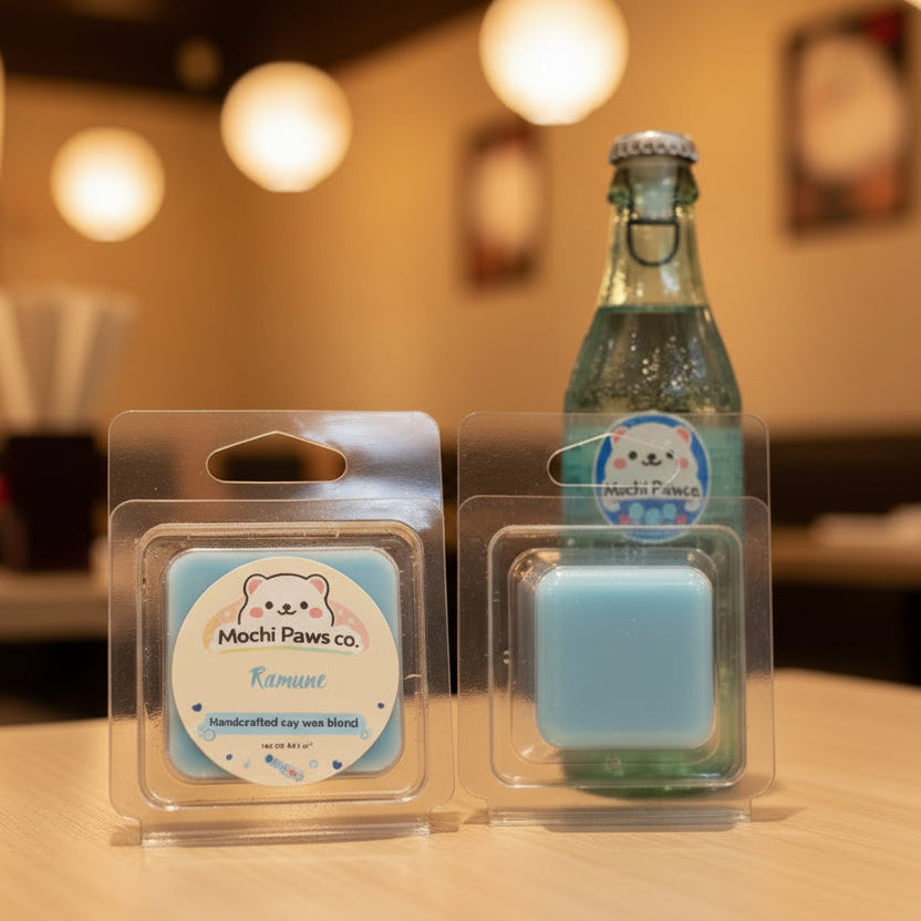 Two wax melts in packaging with a label for Mochi Paws Co. on a table