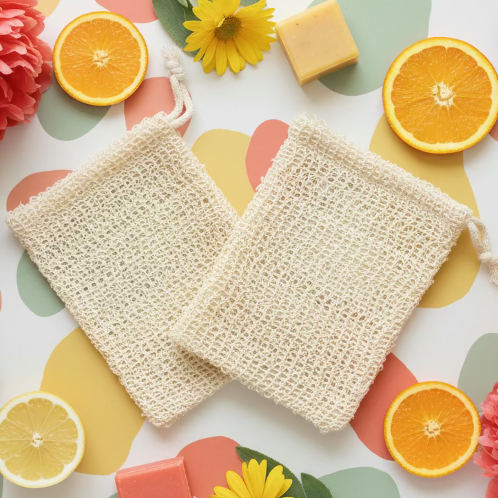 Two beige washcloths on a marble countertop with a blurred bathroom background.