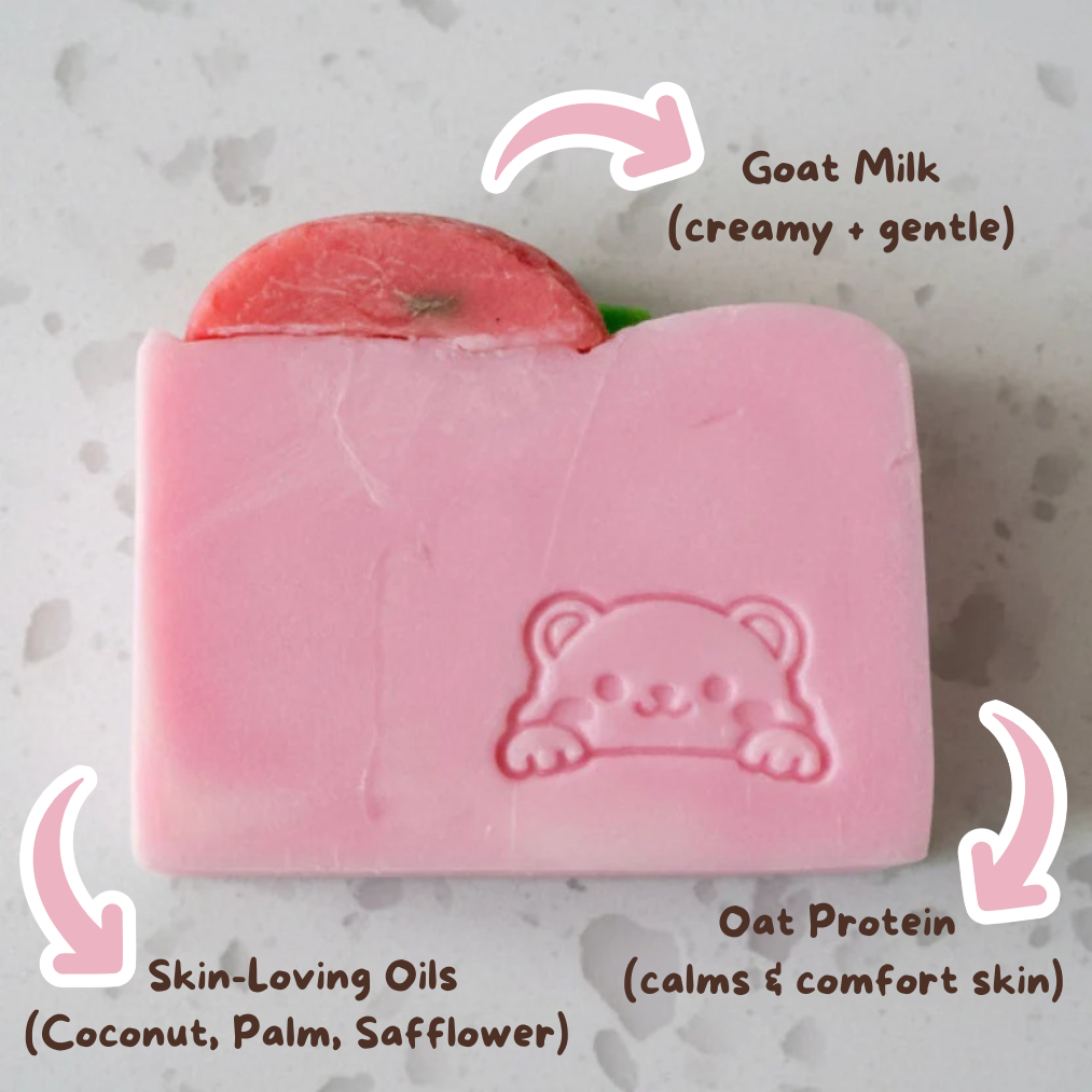 Pink soap bar with a bear design on a gray textured background