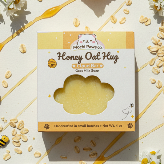 Mochi Paws co. Honey Oat Hug cloud bar goat milk soap packaging on a decorative background with oats and flowers.