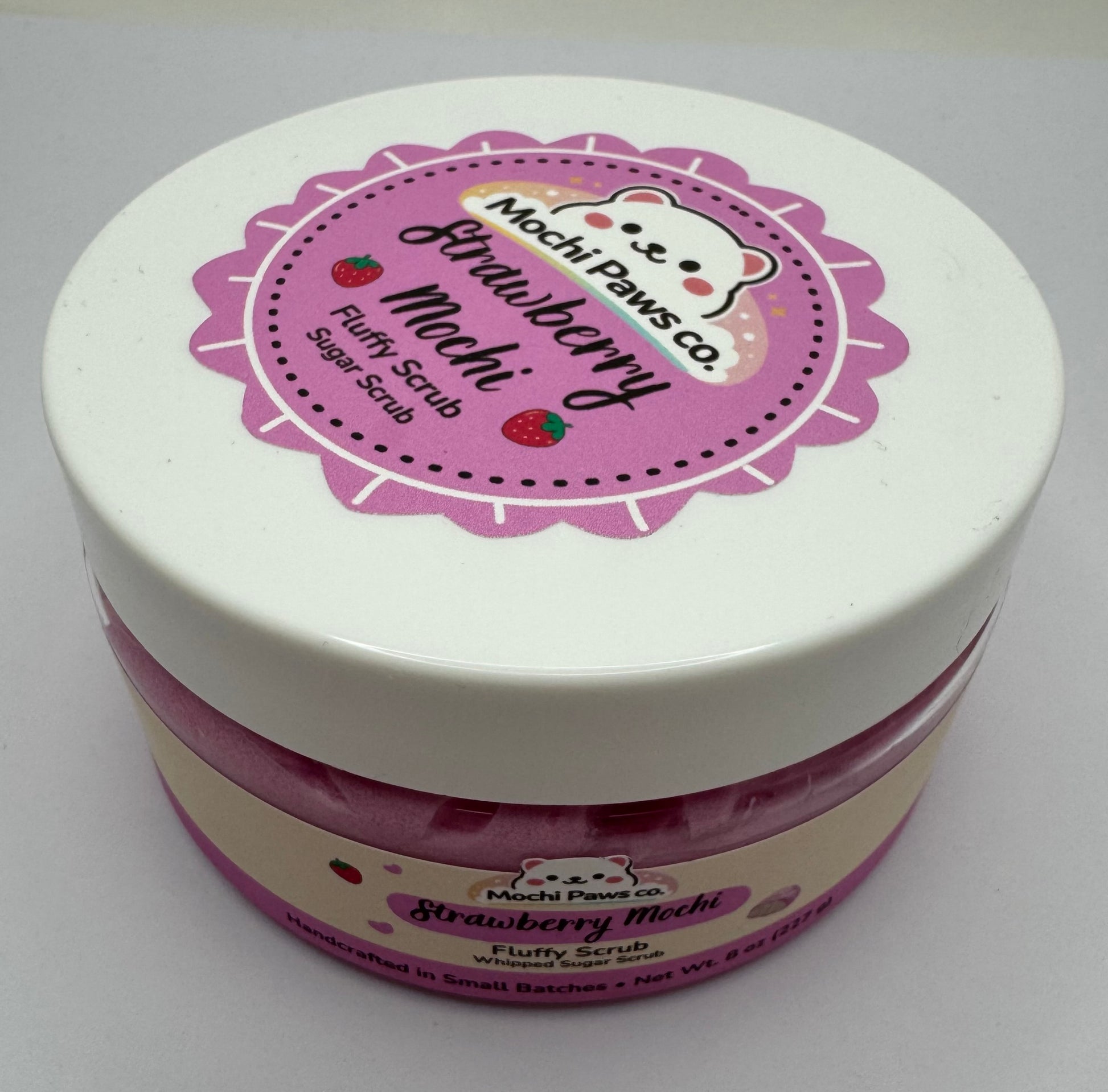 Jar of strawberry-flavored product with a pink label on a white background
